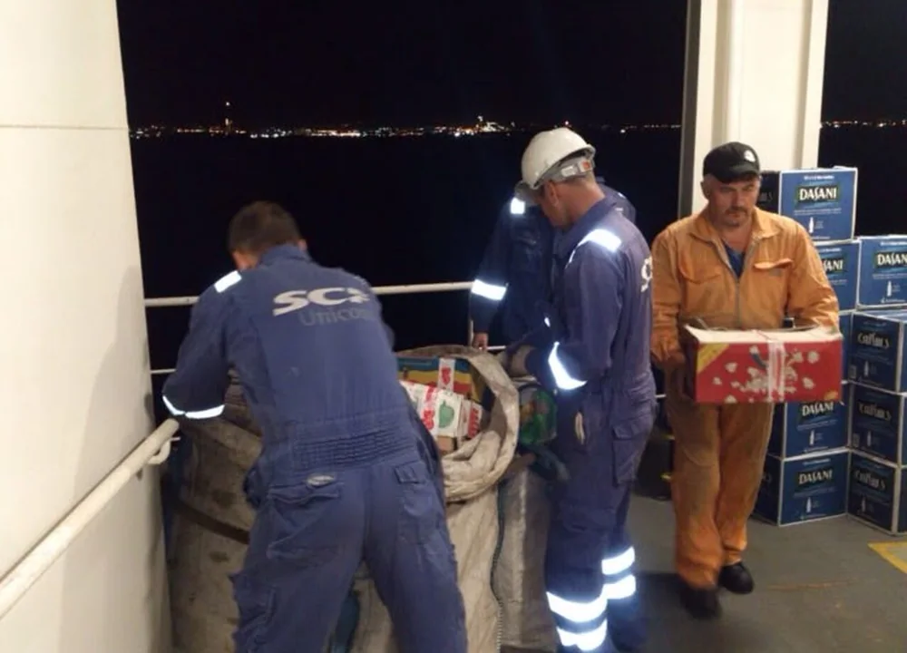 Supplies being delivered to a vessel at night