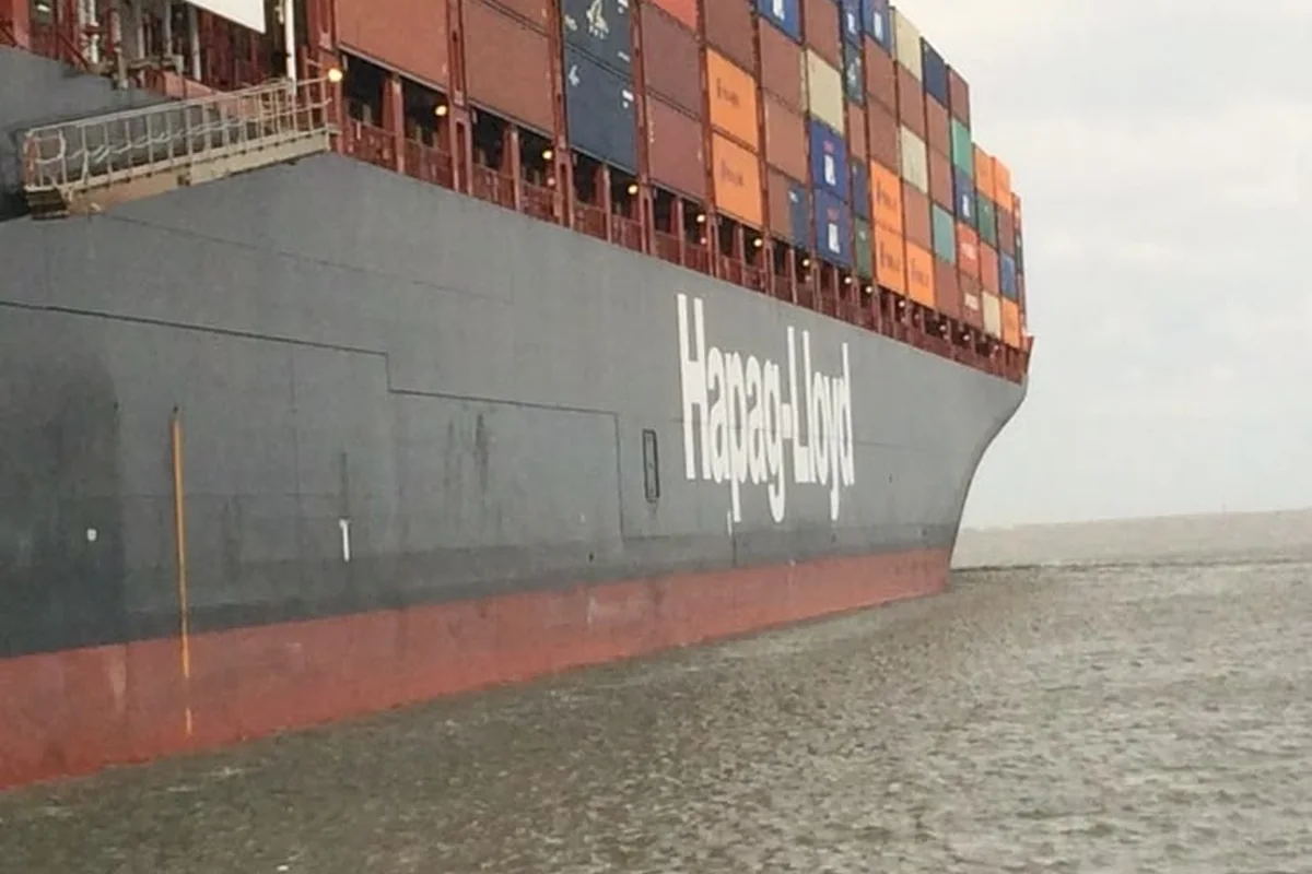 Supply boat alongside a large container vessel